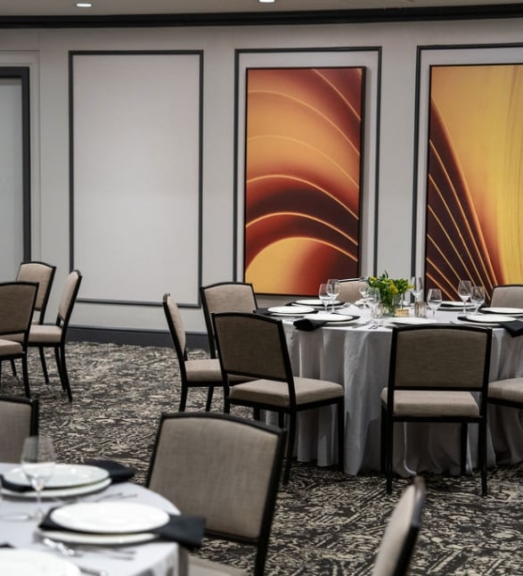 Tables set for a dinner event in the Broadway event room at the Heathman Hotel.