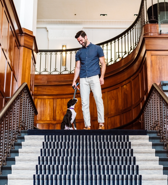A man with his dog in the Heathman Hotel in Portland, Oregon.