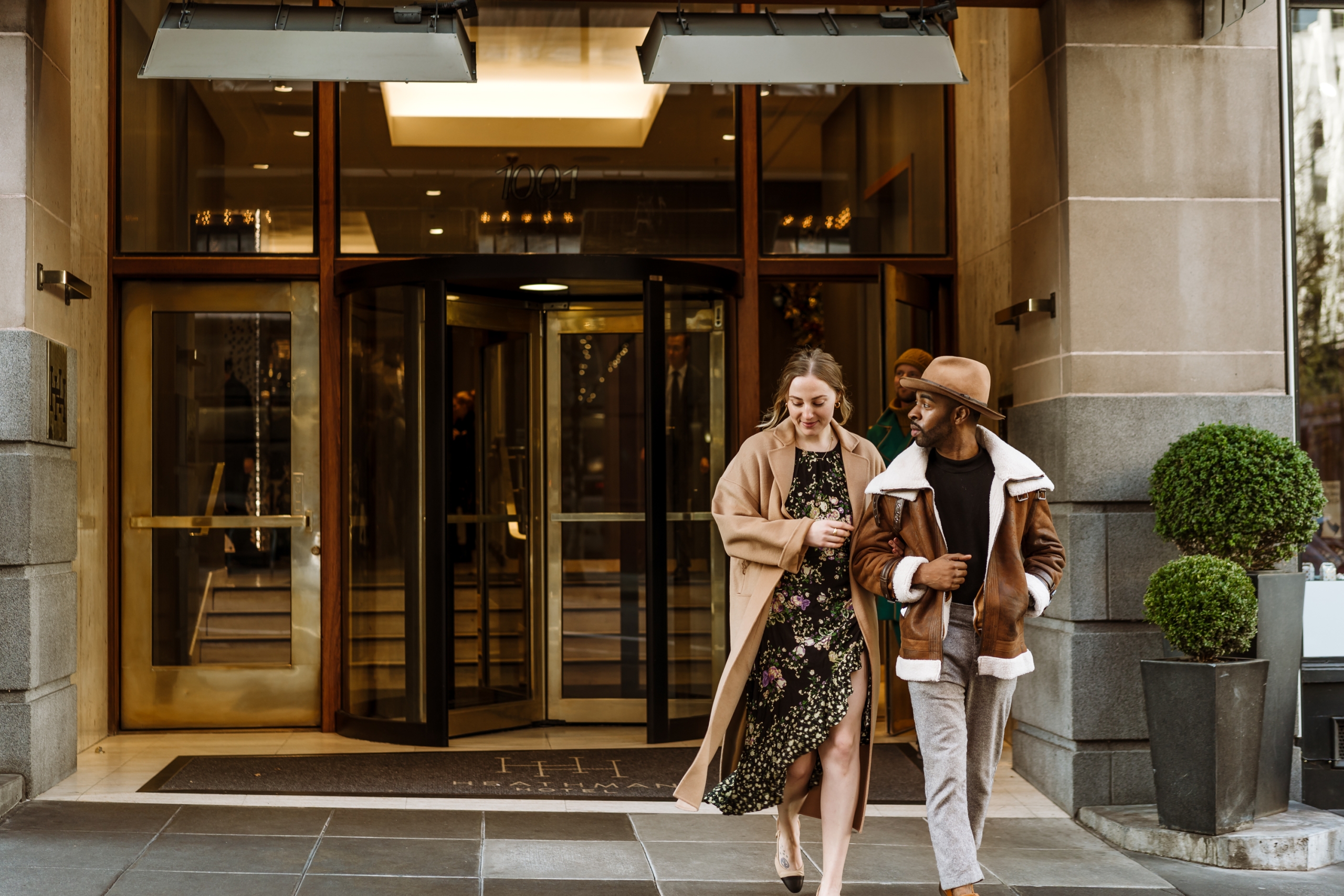 couple walking out of The Heathman Hotel entrance