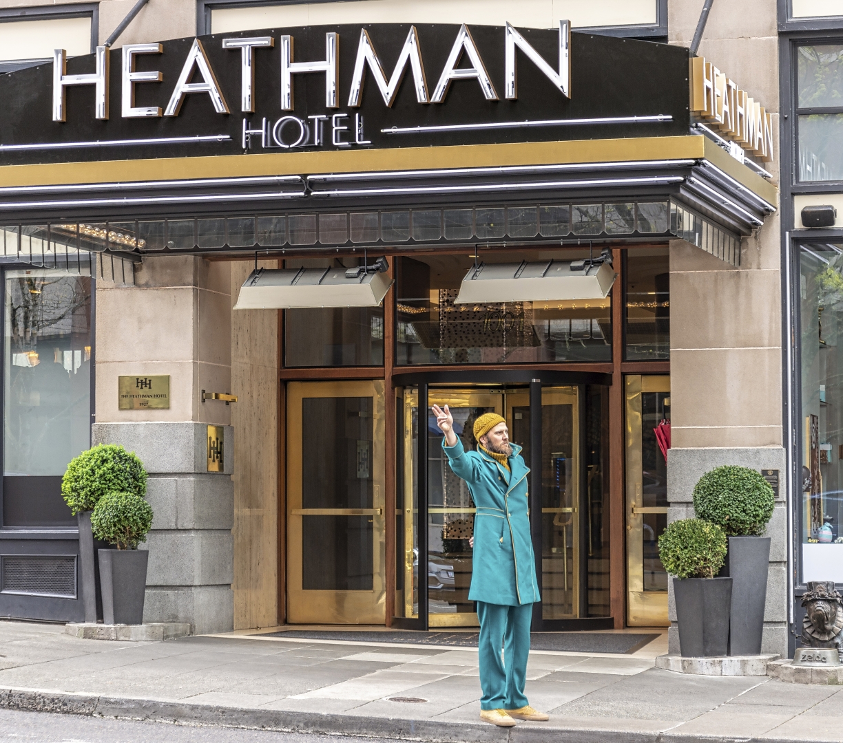 A man hailing a cab in front of the Heathman Hotel in Portland, Oregon.
