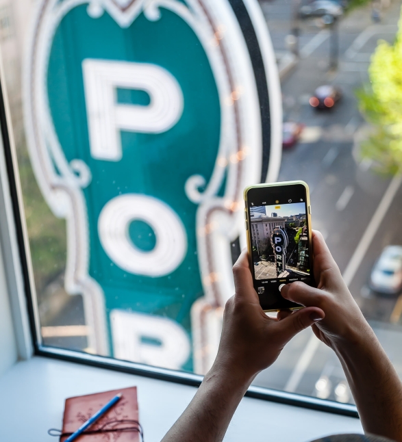 Someone talking a picture of the vertical Portland sign from their hotel room window.