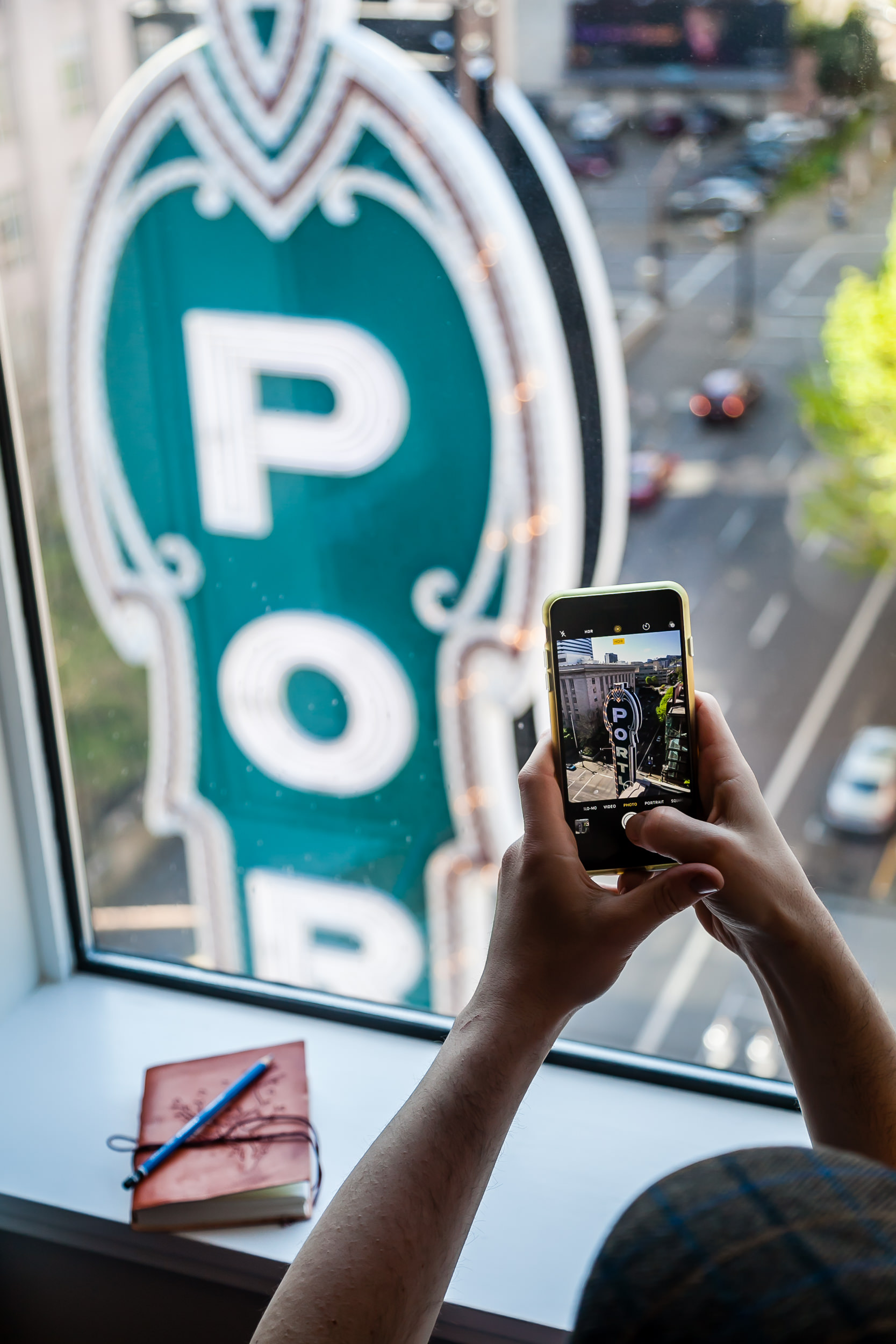 Someone talking a picture of the vertical Portland sign from their hotel room window.