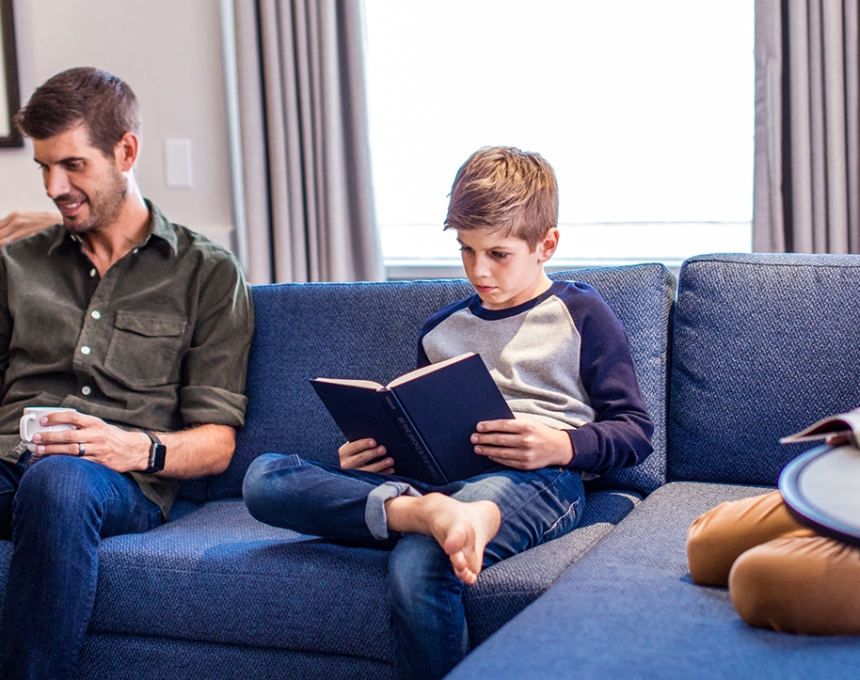 Lovely couple with two boys reading books