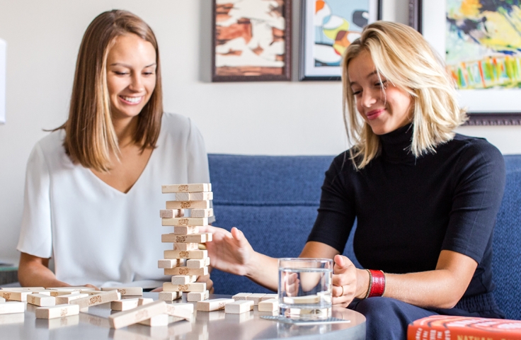 Two ladies playing stone puzzle