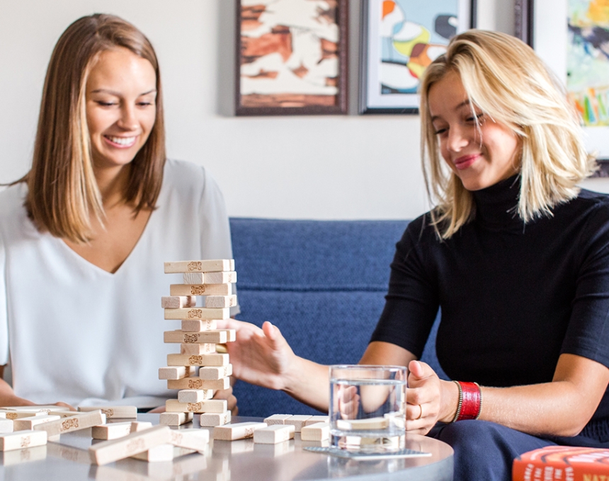 Two ladies playing stone puzzle