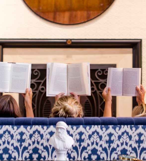 Women on a couch reading books in the Heathman Hotel in Portland, Oregon.