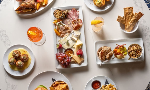 An aerial view of different plates of food on a round table.